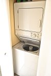 Stackable washer and dryer in the unit.